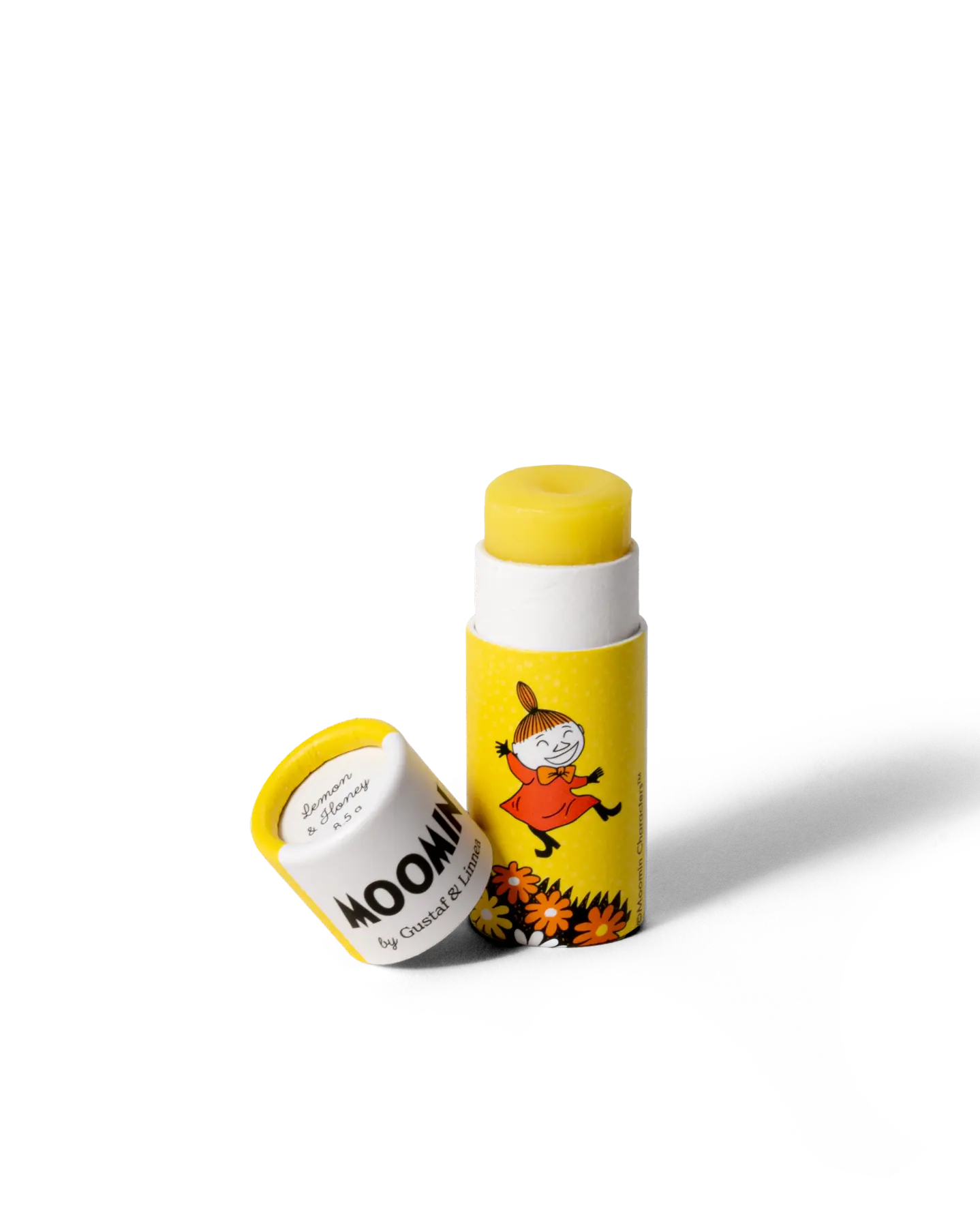 Lip balm and cap with yellow and white label featuring a Moomin character, on a white background